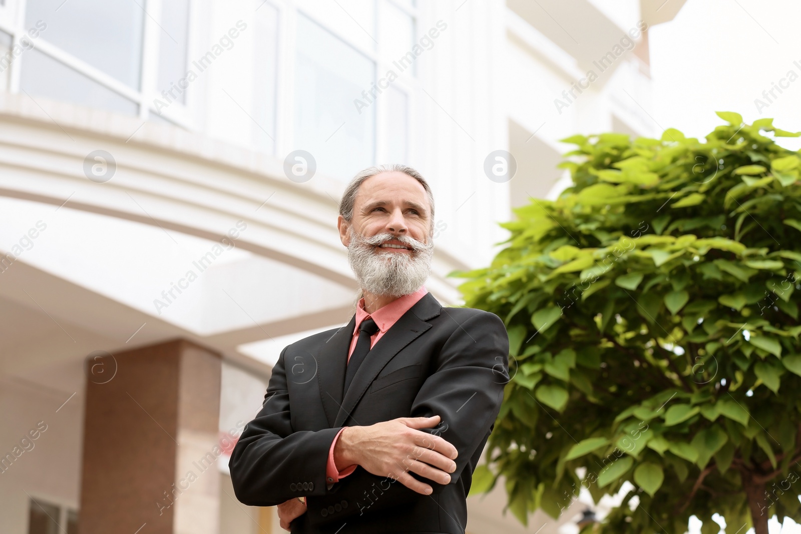 Photo of Handsome bearded mature man in suit, outdoors