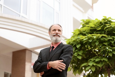 Photo of Handsome bearded mature man in suit, outdoors