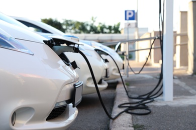 Photo of Charging modern electric cars from station outdoors