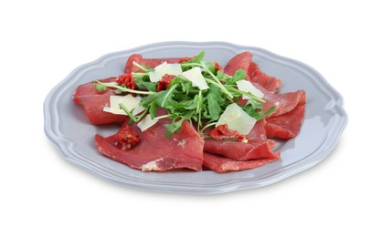 Plate of tasty bresaola salad with sun-dried tomatoes and parmesan cheese isolated on white