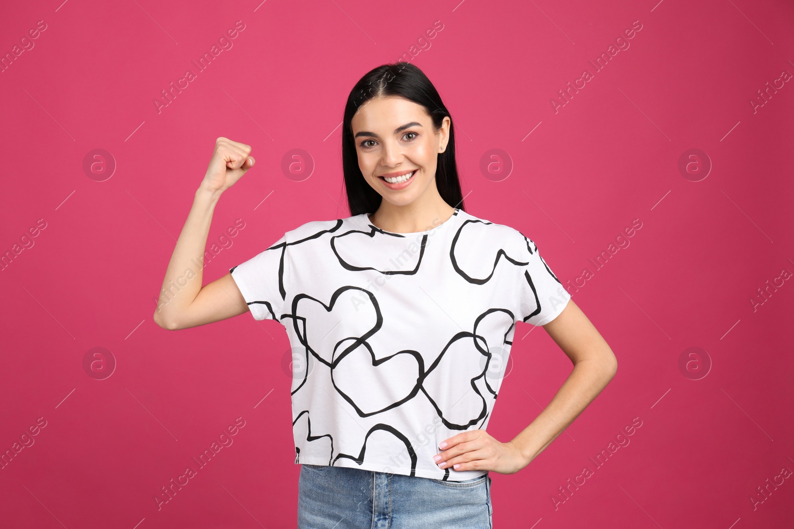 Photo of Strong woman as symbol of girl power on pink background. 8 March concept