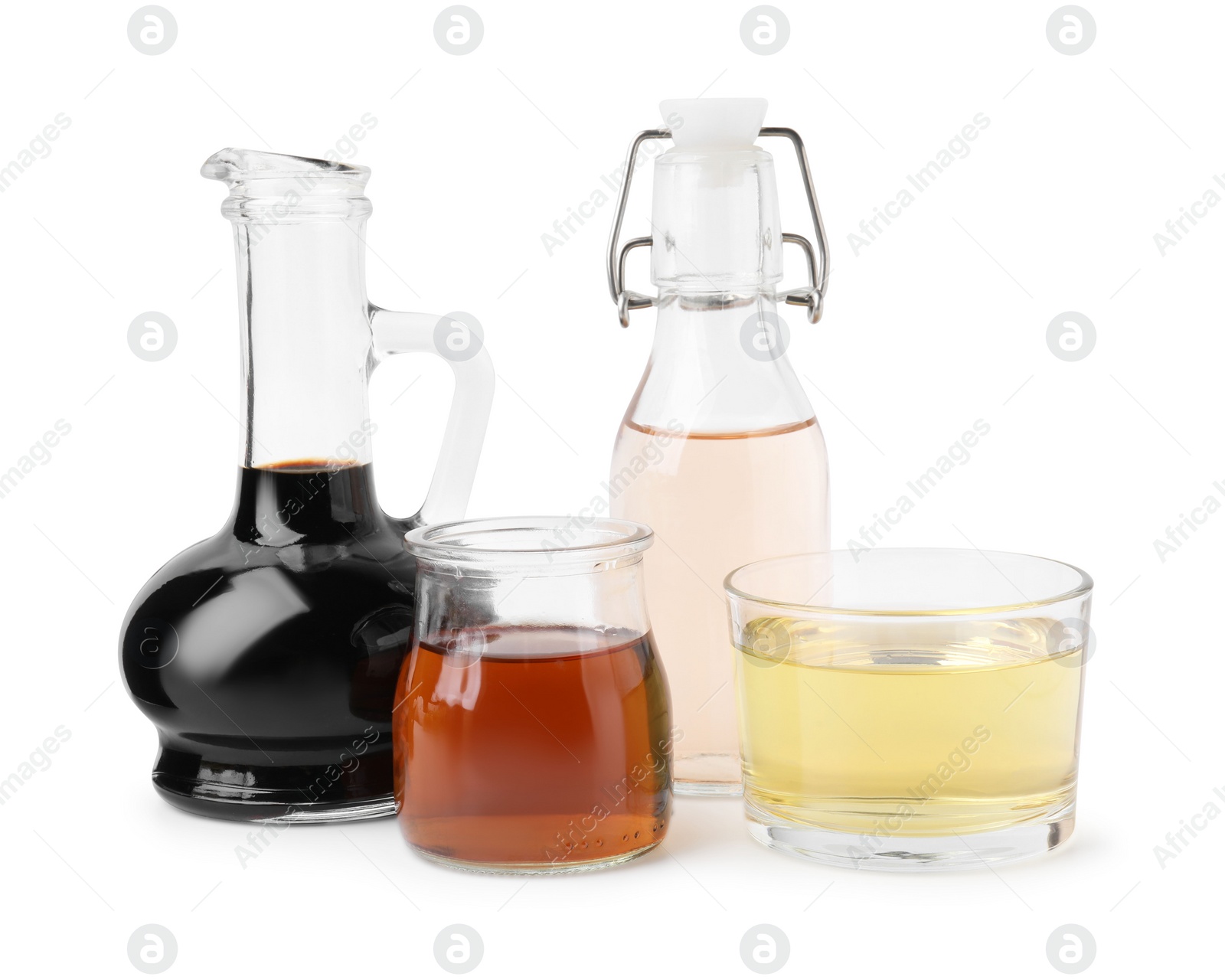 Photo of Different types of vinegar isolated on white