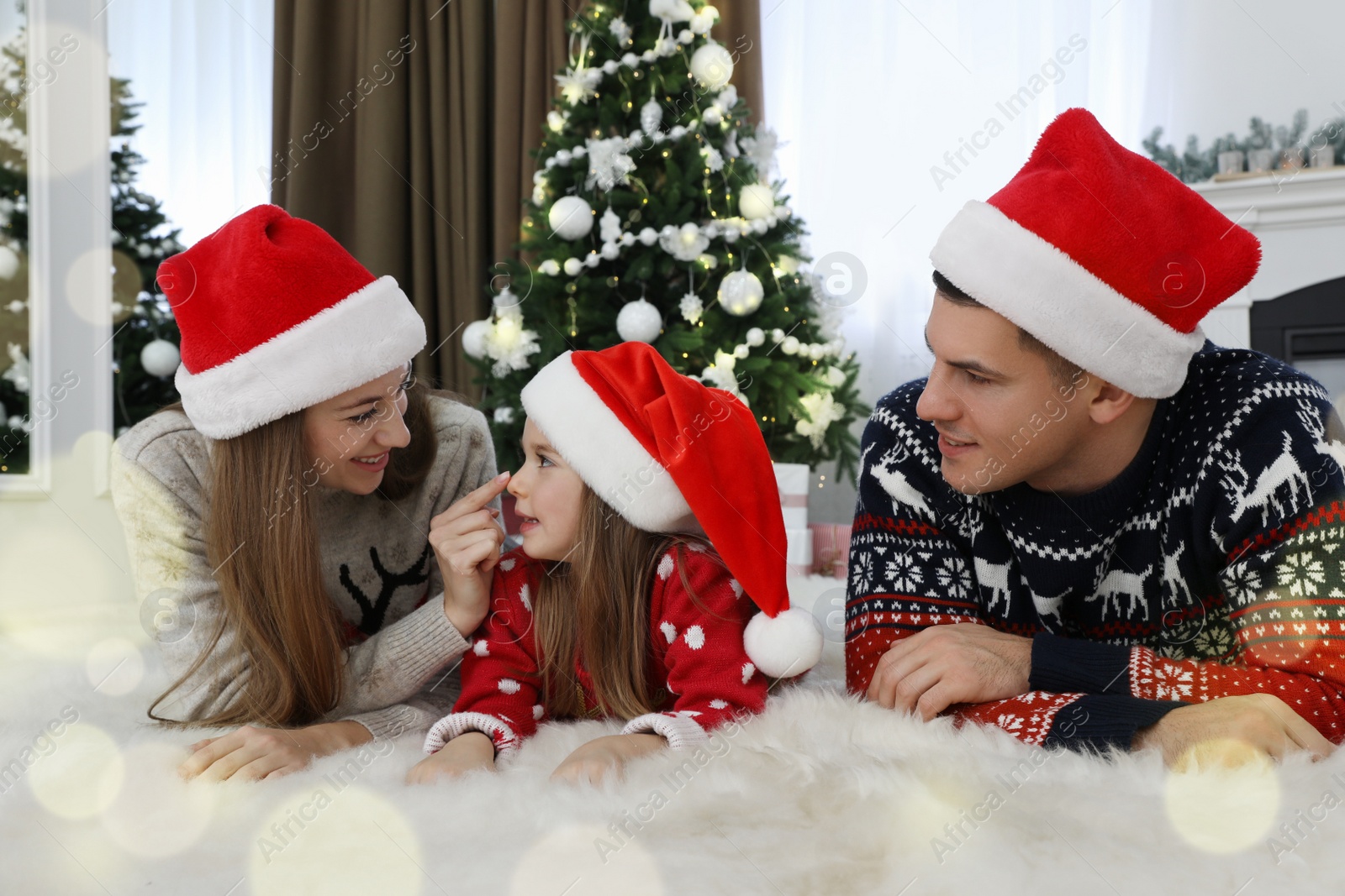 Photo of Happy family in Christmas hats at home