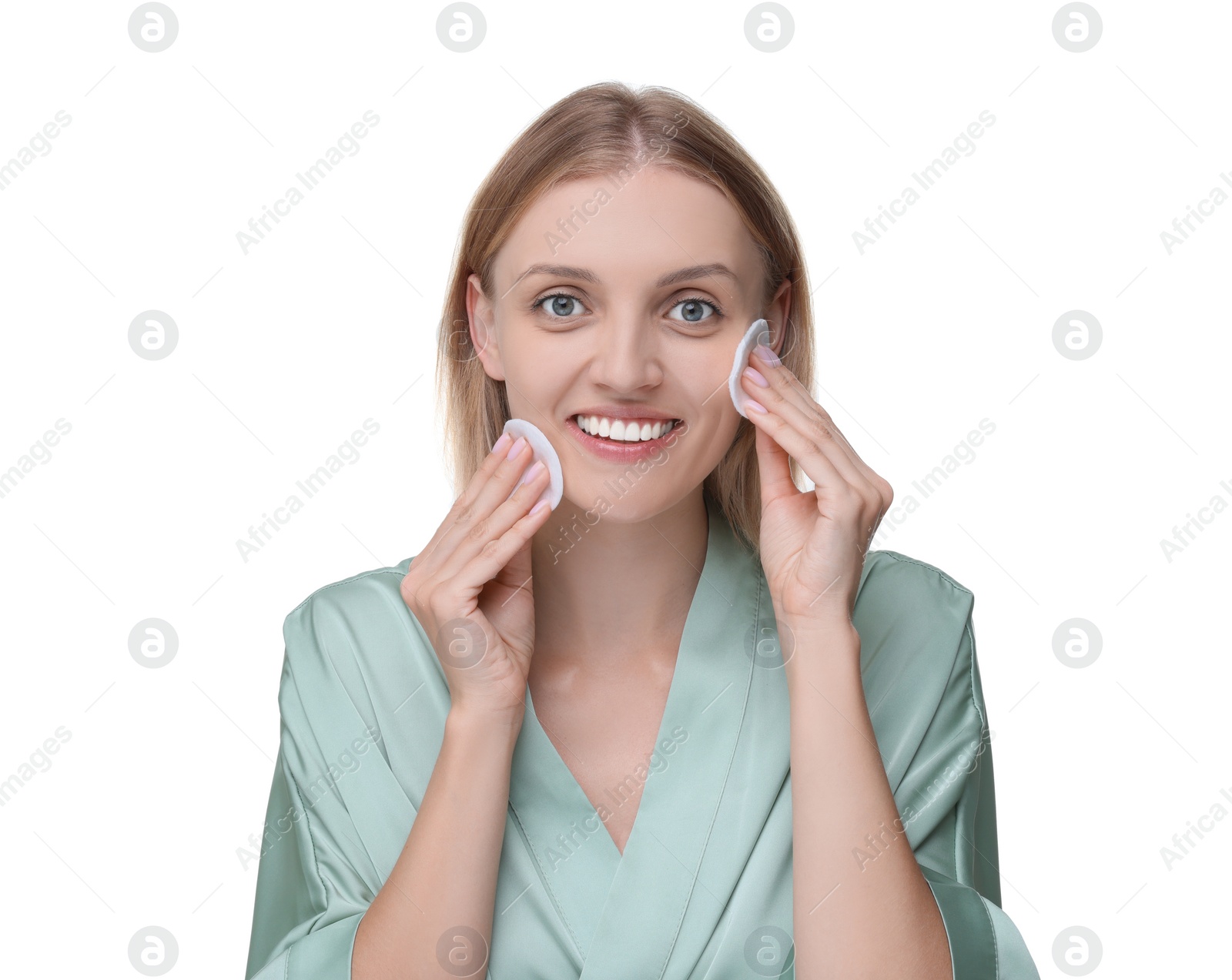 Photo of Young woman cleaning her face with cotton pads on white background