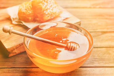 Fresh honey on wooden table, closeup view