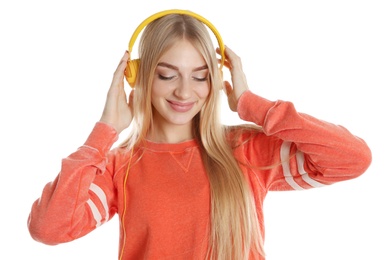 Photo of Beautiful young woman listening to music with headphones on white background