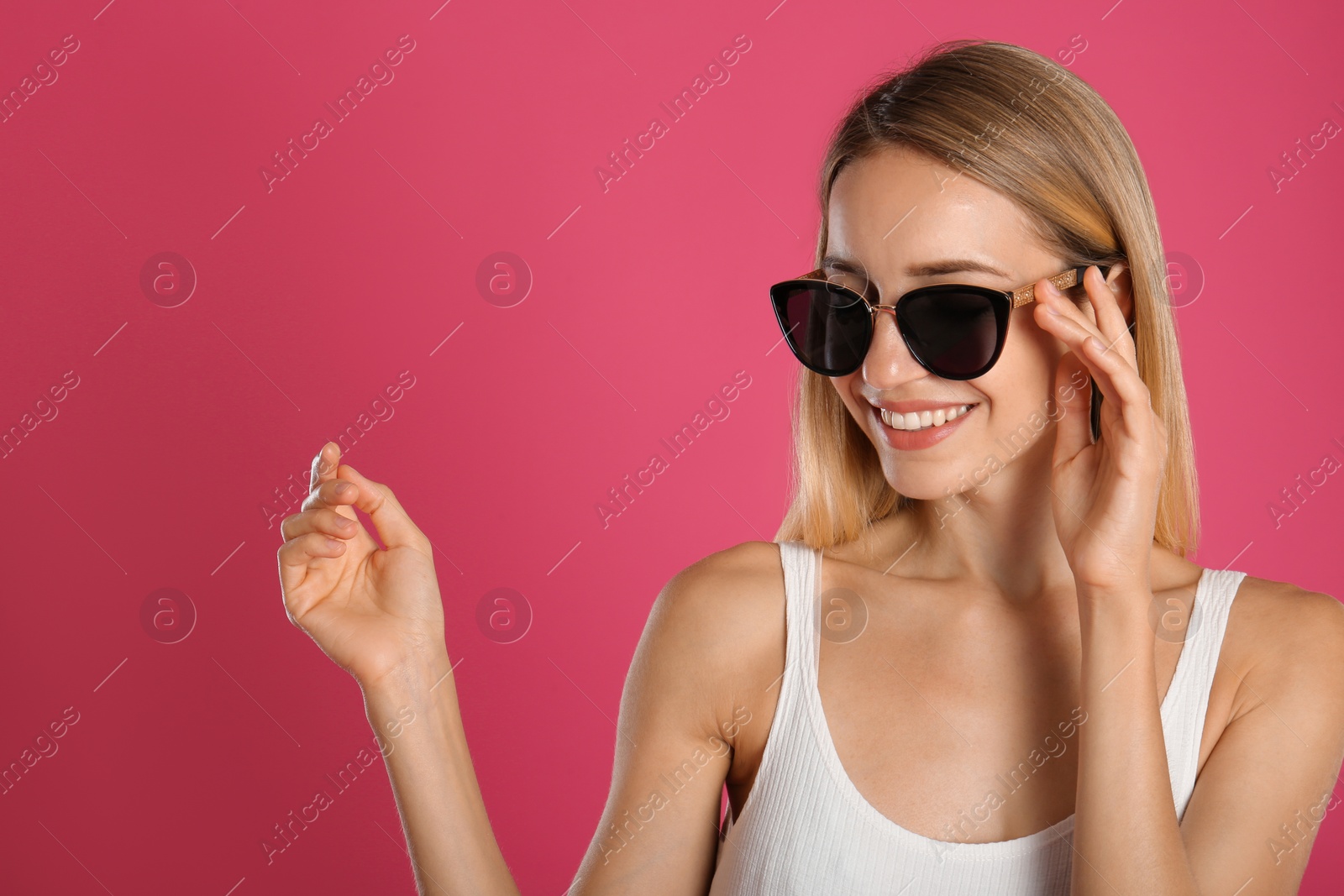 Photo of Beautiful woman in stylish sunglasses on pink background