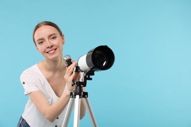 Happy astronomer with telescope on light blue background, space for text