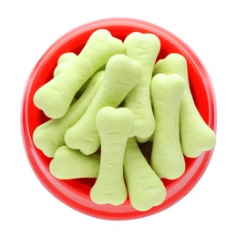 Photo of Bone shaped dog cookies in feeding bowl isolated on white, top view