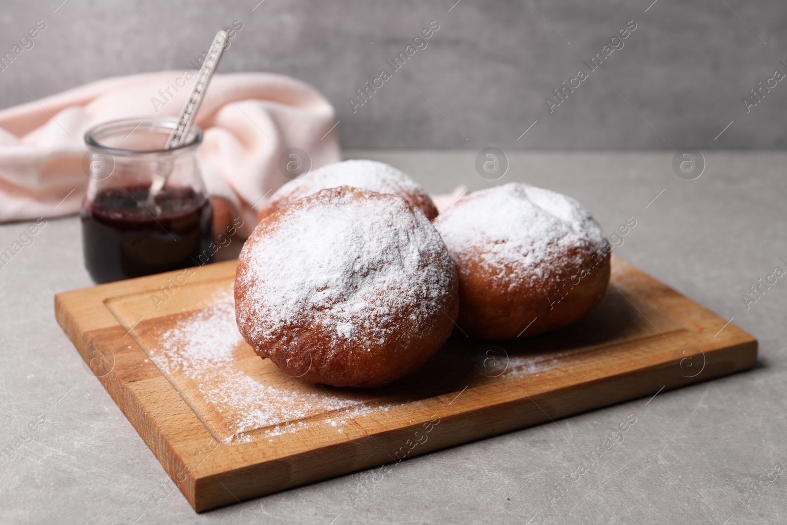 Photo of Delicious sweet buns with jam on gray table