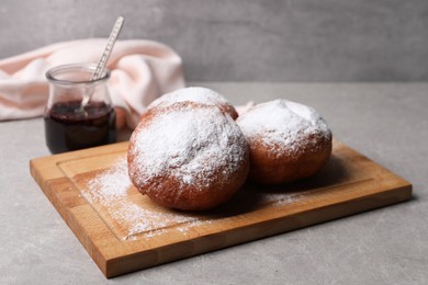 Delicious sweet buns with jam on gray table
