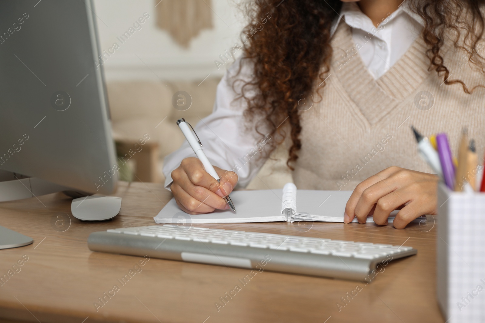 Photo of African American woman studying at home, closeup. Distance learning