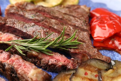 Photo of Delicious grilled beef with vegetables and rosemary on plate, closeup