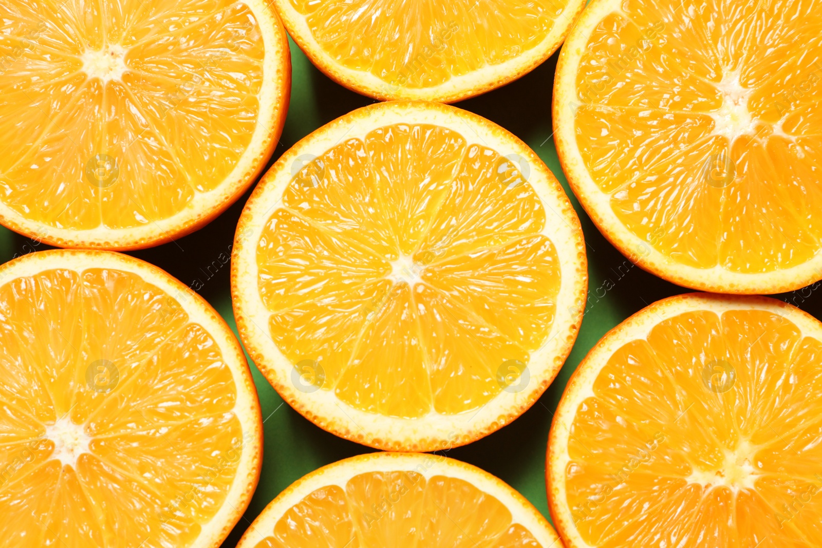 Photo of Halves of ripe oranges as background, top view