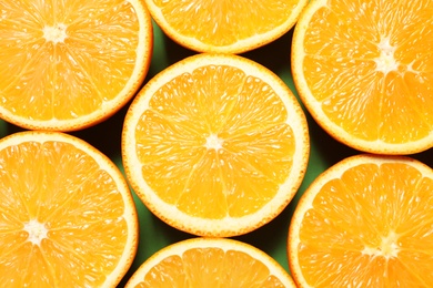 Photo of Halves of ripe oranges as background, top view