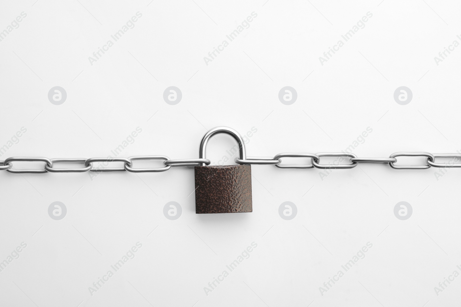 Photo of Steel padlock and chain isolated on white, top view. Safety concept