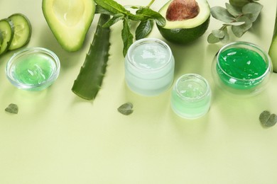 Photo of Composition with homemade cosmetic products and fresh ingredients on light green background, above view. Space for text