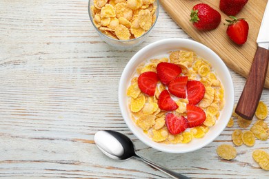 Photo of Bowl of tasty crispy corn flakes with milk and strawberries on white wooden table, flat lay. Space for text
