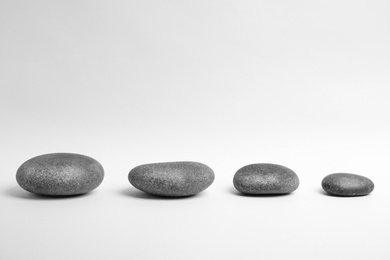 Photo of Zen stones on white background. Space for text