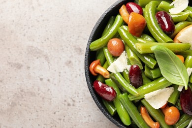 Photo of Delicious salad with green beans, mushrooms and cheese on light grey table, top view. Space for text