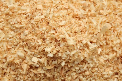 Photo of Dry natural sawdust as background, top view