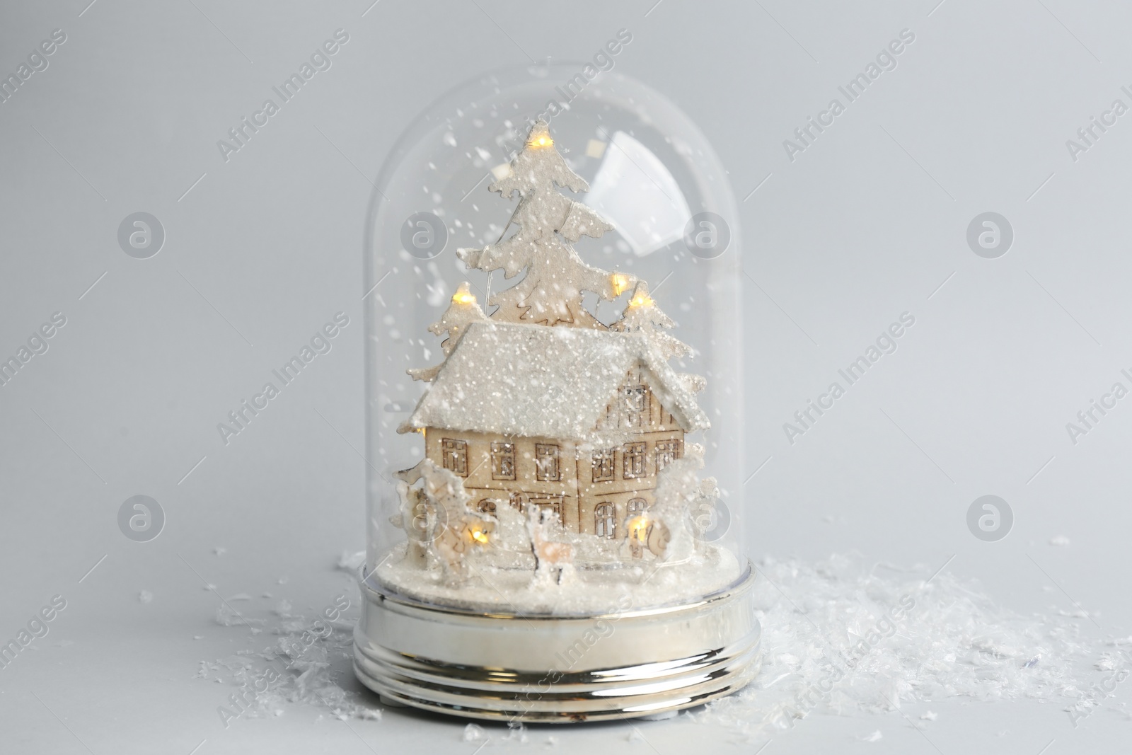 Photo of Beautiful snow globe on light grey background