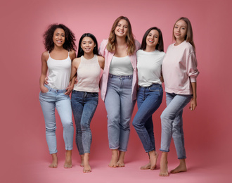 Photo of Group of women with different body types on pink background