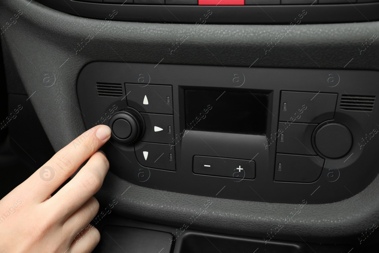 Photo of Woman adjusting air conditioner in car, closeup