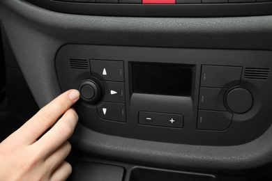 Photo of Woman adjusting air conditioner in car, closeup