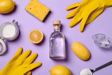 Photo of Flat lay composition with vinegar and cleaning supplies on color background