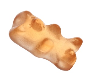 Photo of Delicious orange jelly bear on white background