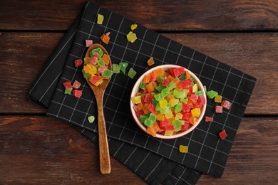 Photo of Mix of delicious candied fruits on wooden table, flat lay
