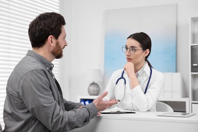 Doctor consulting patient during appointment in clinic