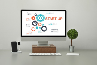 Image of Startup business concept. Computer with illustration of digital marketing plan in office 
