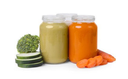 Photo of Jars of healthy baby food and fresh vegetables on white background