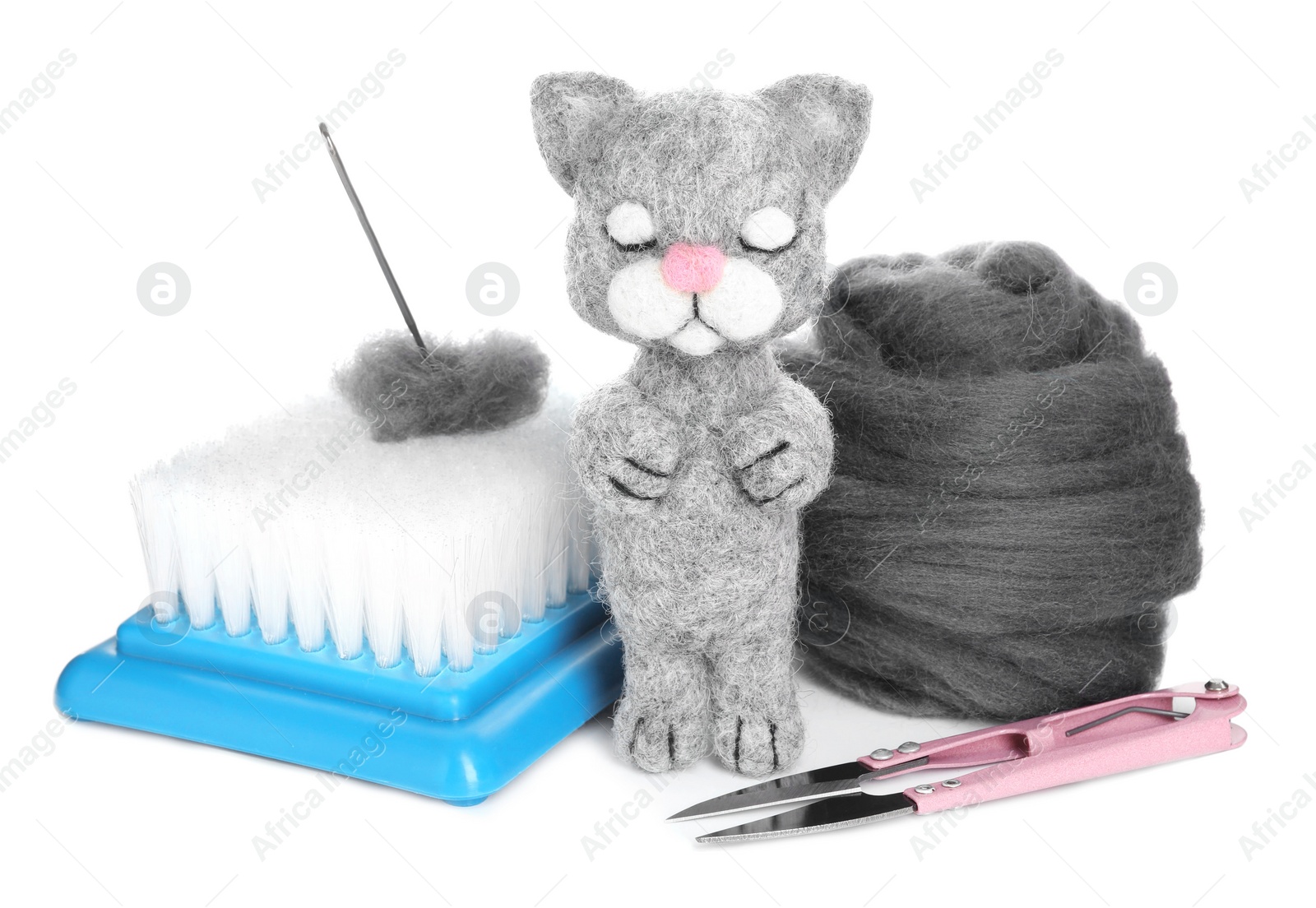 Photo of Needle felted cat, wool and tools isolated on white