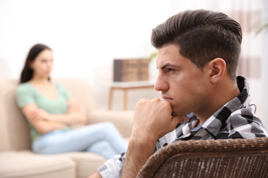 Photo of Unhappy man after quarrel with his girlfriend indoors. Relationship problems