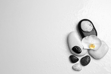 Flat lay composition with spa stones and space for text on white background