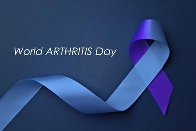 Image of World Arthritis Day. Blue and purple awareness ribbon on color background, top view