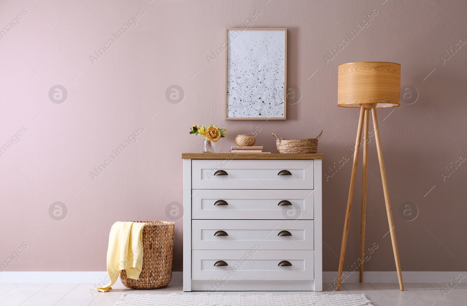 Photo of Elegant room interior with stylish chest of drawers and floor lamp