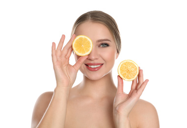 Photo of Young woman with cut lemon on white background. Vitamin rich food