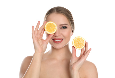 Young woman with cut lemon on white background. Vitamin rich food