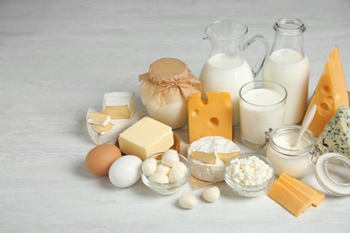 Photo of Different delicious dairy products on white table