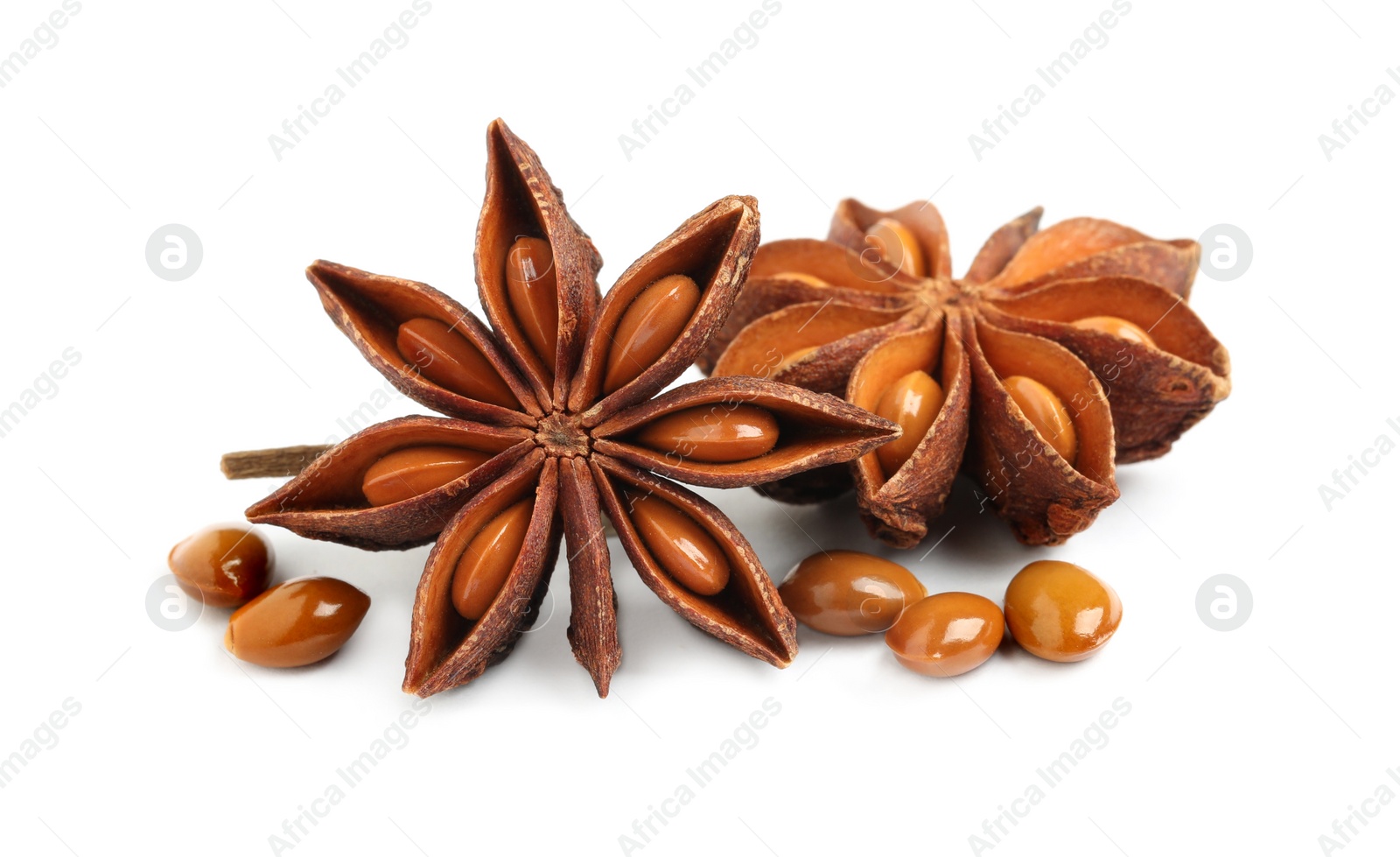 Photo of Dry anise stars with seeds on white background