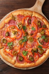 Photo of Delicious pizza Diablo on wooden table, top view