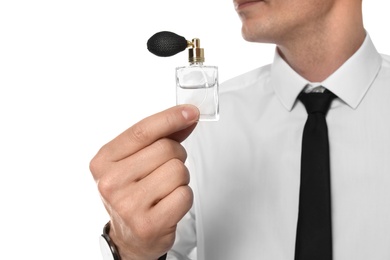 Photo of Handsome man with bottle of perfume on white background, closeup