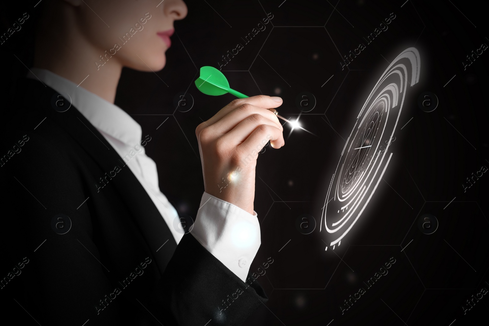 Image of Businesswoman aiming at digital target with dart against dark background, closeup