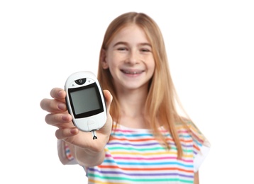 Photo of Teen girl holding glucometer on white background. Diabetes control