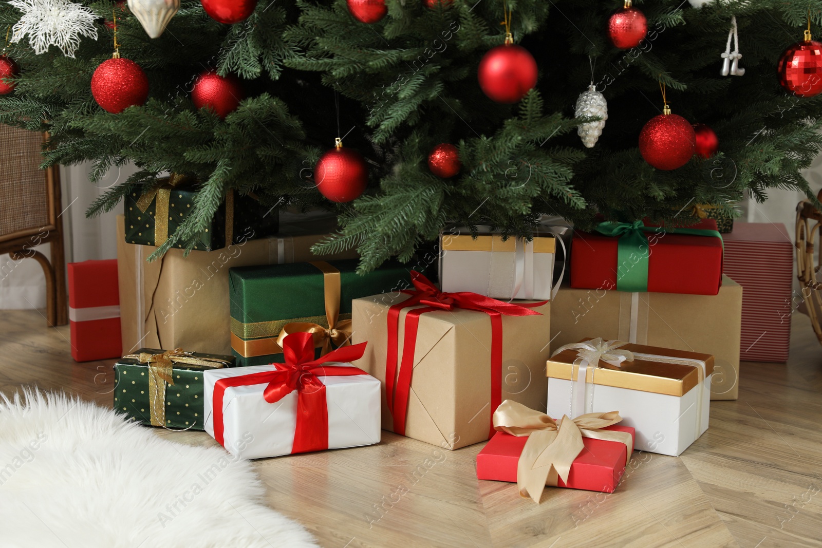 Photo of Beautifully decorated Christmas tree and gifts indoors