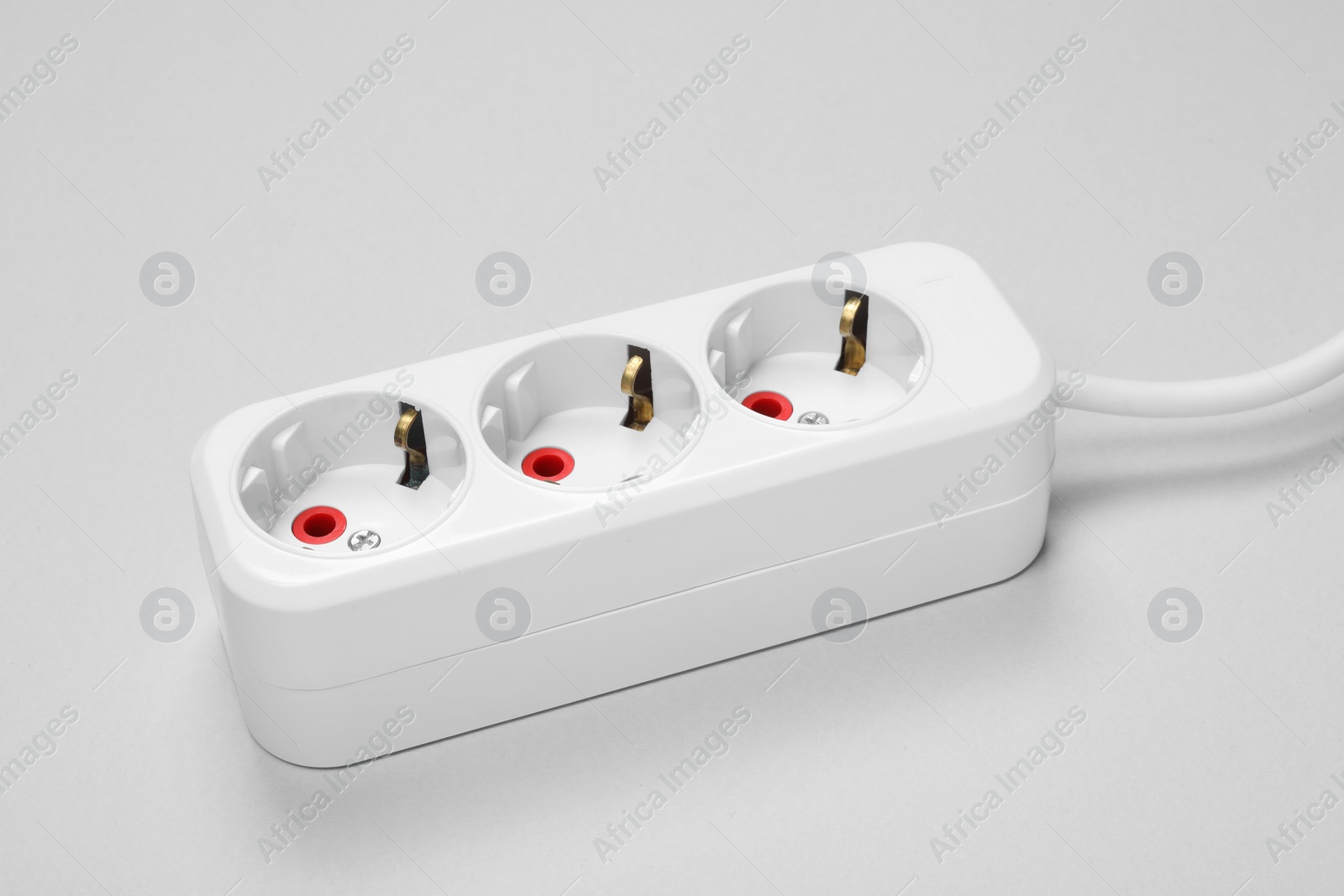 Photo of Power strip on white background, closeup view